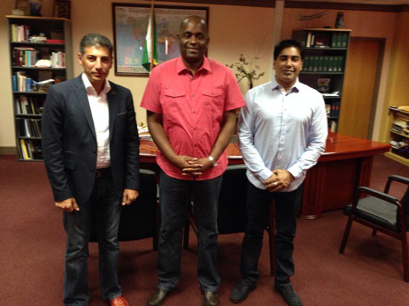 Manoj Bullah, right, was a witness to Alireza Monfared, left, receiving a diplomatic passport from Dominican Prime Minister Roosevelt Skerrit, centre.